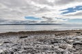 Rocks and beach with Cliffs of Moher in background in Inisheer island