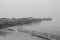 Rocks by the beach on a foggy day - stock photo