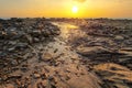 Rocks and beach uncovered in low tide with boats Royalty Free Stock Photo