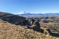 rocks of Bermamyt Plateau and view of Mount Elbrus