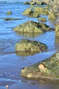 Rocks in blue seawater in patter or interval