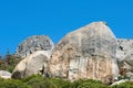 Rocks and boulders on a mountain peak with green lush bush growing on Lions Head in Cape Town with sky and copyspace Royalty Free Stock Photo
