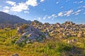 Rocks and boulders in an uncultivated, rough hiking terrain on Table Mountain, Cape Town, South Africa. Lush green Royalty Free Stock Photo