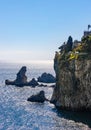 Rocks and cliffs of Capo Taormina cape on Ionian sea shore aside Giardini Naxos town in Messina region of Sicily in Italy Royalty Free Stock Photo