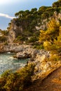 Rocky shoreline sunset landscape of Cap Ferrat cape hosting Saint-Jean-Cap-Ferrat resort town near Nice in France Royalty Free Stock Photo