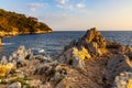 Rocky shoreline sunset landscape of Cap Ferrat cape hosting Saint-Jean-Cap-Ferrat resort town near Nice in France Royalty Free Stock Photo