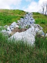 Rocks climbing a hill jagged and sticking out all different colors brown gray green blue