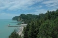 The rocks come close to the sea. A sea bay surrounded by forest. The azure Sea. Sandy beach. Pier. Musser. Abkhazia Royalty Free Stock Photo