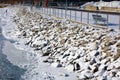 Rocks covered with snow in cold river after winter storm riverside in Detroit