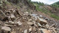 Rocks and debris tumble down the steep incline of a newly formed rift unsettling the already unsteady ground Royalty Free Stock Photo