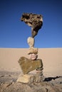 Rocks in a desert are balanced in a precarious manner