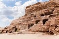 Rocks dotted with the caves carved by Nabatean craftsmen in Nabatean Kingdom of Petra in the Wadi Musa city in Jordan Royalty Free Stock Photo