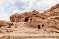 Rocks dotted with caves carved by Nabatean craftsmen in Nabatean Kingdom of Petra in the Wadi Musa city in Jordan Royalty Free Stock Photo