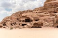 Rocks dotted with many caves carved by Nabatean craftsmen in Nabatean Kingdom of Petra in the Wadi Musa city in Jordan Royalty Free Stock Photo