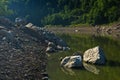 Rocks fallen into water of Uvac river at sunny summer morning