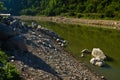 Rocks fallen into water of Uvac river at sunny summer morning