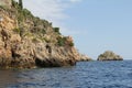 Rocks falling into the sea, covered with cacti and plants, rocks and the coast of the Ionian Sea, Sicily