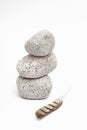 Rocks and feather on white background in the studio Royalty Free Stock Photo