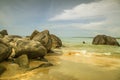 Rocks in front of the shining turquoise-blue Indian Ocean