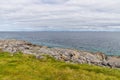Rocks, grass and beach in Inisheer Island