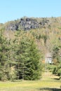 Rocks and house among pine and birch trees in Czech Switzerland