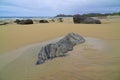 Rocks on isolated sand beach Royalty Free Stock Photo
