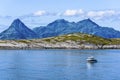 Rocks of Landegode island as seen behind Hjartoya Island in Bodo Municipality, Nordland county of Norway. Water of Norwegian Sea