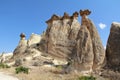 Rocks looking like mushrooms dramatically lit by a sun in Chavushin in Cappadocia, Turkey.
