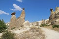 Rocks looking like mushrooms dramatically lit by a sun in Chavushin in Cappadocia, Turkey.