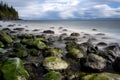 Rocks in the Mystic beach surrounded by the sea with long exposure in Canada