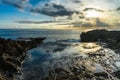 Rocks near the sea. Sunset sky reflected in the pools Royalty Free Stock Photo