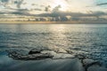 Rocks near the sea. Sunset sky reflected in the pools Royalty Free Stock Photo