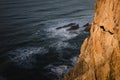 Rocks and ocean surf near the Portuguese lighthouse Cabo da Roca, Sintra, Portugal.