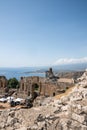 Rocks at old ruins of ancient Greek theater at seacoast in summer