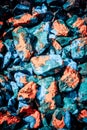 Rocks orange, blue and green paint stains Royalty Free Stock Photo