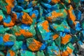 Rocks orange, blue and green paint stains Royalty Free Stock Photo