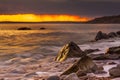 Rocks at Osmington Reflecting Sunset Colours