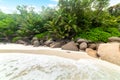 Rocks and palm trees in famous Anse Georgette beach in Praslin island Royalty Free Stock Photo