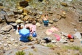 View of rocks, people geeting sun, Salivoli, in Livorno, Tyscuny, Italy Royalty Free Stock Photo