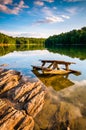 Rocks and a picnic table in Lake Marburg, at Codorus State Park, Pennsylvania. Royalty Free Stock Photo