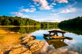 Rocks and a picnic table in Lake Marburg, at Codorus State Park, Pennsylvania. Royalty Free Stock Photo