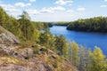 Rocks with a pine forest above the water of a lake or the Gulf of Finland. Squirrel rocks on a clear sunny day Royalty Free Stock Photo