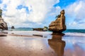 Rocks are reflected in the wet sand Royalty Free Stock Photo