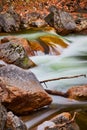 Rocks in river with cascading waters in early spring