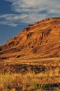 Wonderful sunset with white clouds in the sky over the rocks in the Sahara Desert in Morocco. Royalty Free Stock Photo