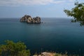 Rocks in the sea on the backgrounf of the blue cloudy sky