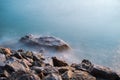 Rocks by the sea with beautiful smooth water in sunlight