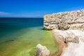 Rocks sheer and stones on the seashore on a clear day Royalty Free Stock Photo