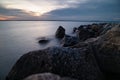 rocks are on the shore at sunset on a clear day Royalty Free Stock Photo