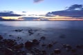 Rocks on the shore of the lake at sunset